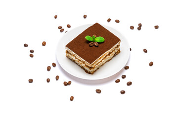 Traditional Italian Tiramisu square dessert portion on ceramic plate and coffee beans isolated on white