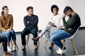 Fototapeta premium African American psychotherapist talking to participants of a group therapy.