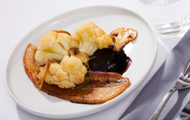 Cauliflower with bacon and mushrooms. High quality photo