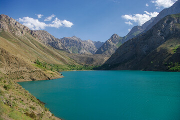 Fototapeta na wymiar Turquoise blue Marguzor lake in scenic mountain landscape in the seven lakes area, Shing river valley, near Penjikent or Panjakent, Sughd province, in Tajikistan