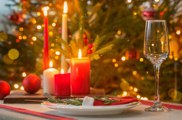Christmas table with candles on background fir