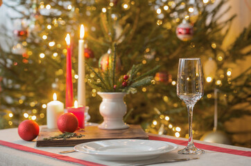 Christmas table with candles on background fir