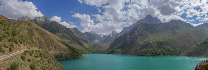 Turquoise blue Marguzor lake in scenic mountain landscape in the seven lakes area, Shing river valley, near Penjikent or Panjakent, Sughd province, in Tajikistan