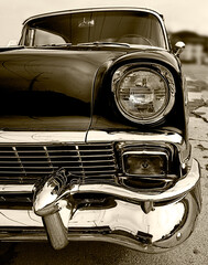 Headlight and grill of a classic car.