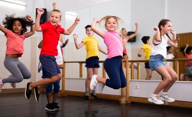 Poster Dance class for kids, positive girls and boys training in dance studio © JackF