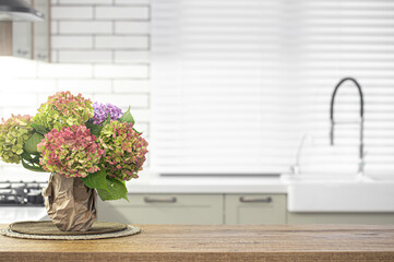 Bouquet of hydrangeas on the kitchen table close up on a blurred background.