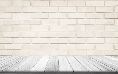 Empty wooden table top on cream brick wall background, Design wood terrace white. Perspective for show space for your copy and branding. Can be used as product display montage. Vintage style concept.