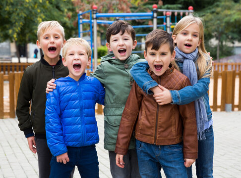 Joyful children on street of autumn city. High quality photo