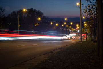 Fototapeta na wymiar White and red traffic lights shot at long exposure going downhill.