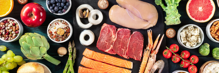 Food panorama, top shot. Beef, chicken, salmon, rice, cheese, fruit and vegetables, an assortment...