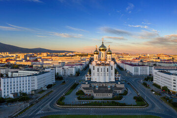 Picturesque morning cityscape. Aerial view of the city of Magadan. View of the large cathedral, streets and buildings at sunrise. Holy Trinity Cathedral, Magadan, Magadan Region, Far East of Russia.