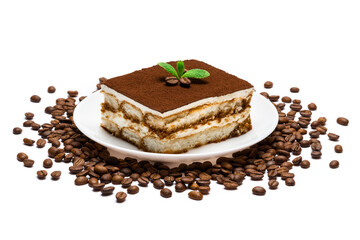 Traditional Italian Tiramisu square dessert portion on ceramic plate and coffee beans isolated on white