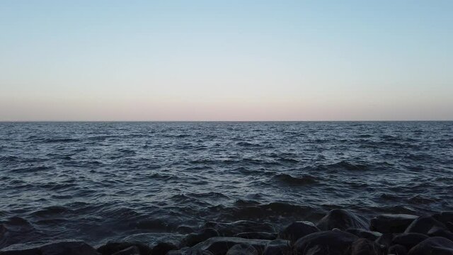 water surface with small waves at the shore