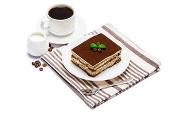 Traditional Italian Tiramisu dessert square portion on ceramic plate and cup of fresh espresso coffee isolated on white