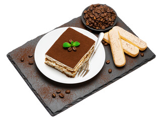 Traditional Italian Tiramisu square dessert portion on ceramic plate, savoiardi cookies and coffee beans on stone serving cutting board isolated on white