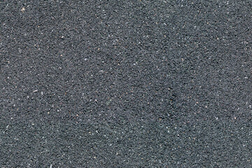 Seamless black background with asphalt. Endless texture with road surface. Dark backing with small splashes of white.