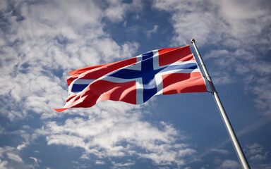 Norway national flag waving at sky background close-up.