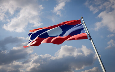 Laos national flag waving at sky background close-up.