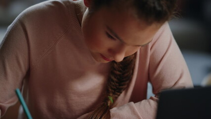 Clever student schooling remotely. Diligent girl doing math homework indoors.