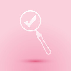 Paper cut Magnifying glass and check mark icon isolated on pink background. Magnifying glass and approved, confirm, done, tick, completed symbol. Paper art style. Vector.