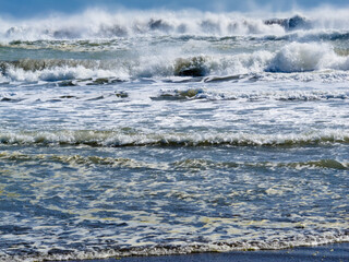 Waves breaking and rolling on beach background
