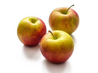 Three seasonal apples, red-yellow color, on a white background