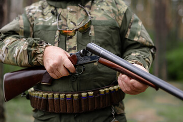 Old Man Hands Charging Rifle Hunting in Forest.