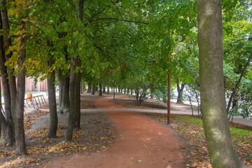 A winding path of red sand in the park. Selective focus