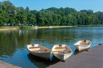 Obraz premium Three docks near the pier for walks on the lake, boat rental. Selective focus