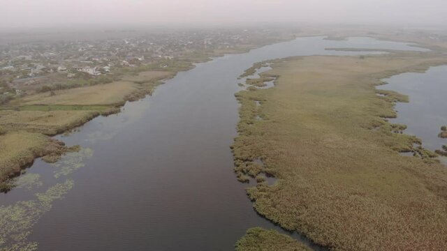 Aerial view of the Misty Autumn Floodplains of the Dnieper River with Reed islands in the river