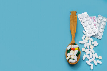 Vitamins and antibiotics on a blue background, copy space. Close-up, selective focus
