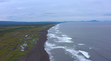 Seascape of Kamchatka. Majestic cliffs, hills and mountains.