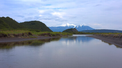 Fototapeta na wymiar Beautiful volcanoes of Kamchatka. Hills, mountains and plains of Kamchatka.