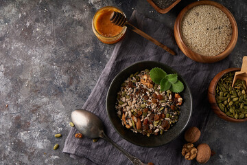 Healthy breakfast, seed and nut mix with honey and mint
