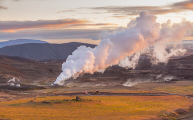Steam column associated with the Krafla geothermal power plant in northern Iceland at setting sun