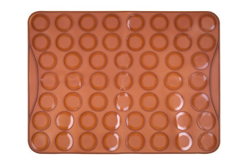 Brown silicone baking mat for macaroons isolated on white background, copy space. Clipping path. Top view, flat lay