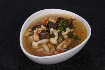 Thai style soup with meat and mushrooms