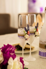The wedding glasses and drink bottles decorated for the wedding stand on the holiday table