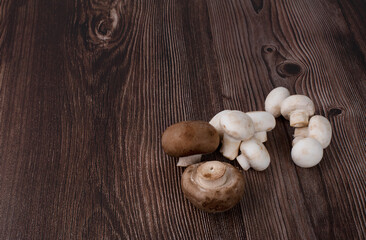 Fresh champignon mushrooms isolated on wooden table