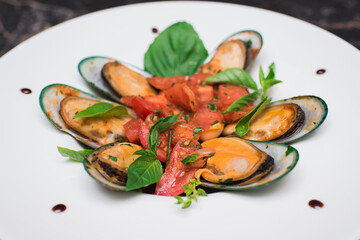 Mussels in pink sauce with white wine on a white plate