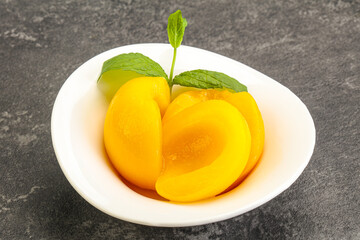 Sweet ripe canned peaches with mint