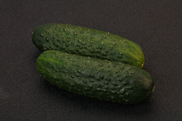 Green fresh cucumbers over background