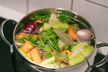 Vegetables cooking in the kitchen pot making a soup