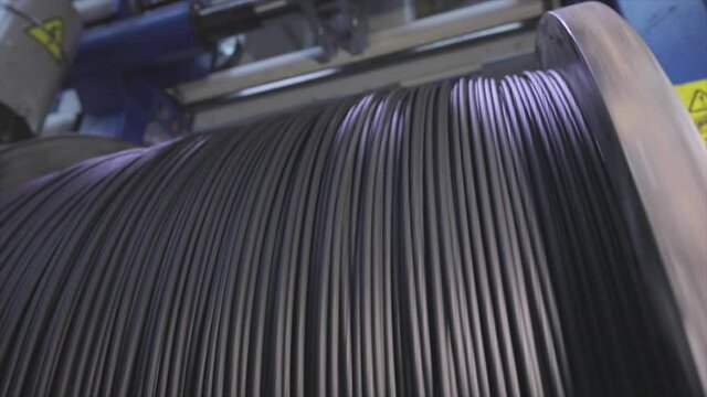 Cable factory. Winding of the electrical cable to the bobbin in the production. Cable pdroduction. Closeup