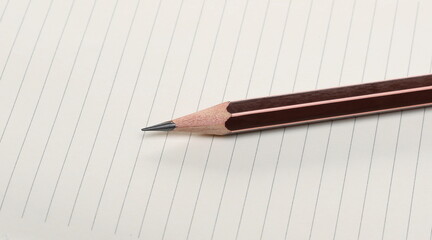 Blank white lined, ruled paper sheet with graphite pencil background and texture