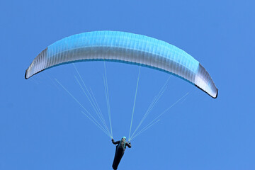 Paraglider flying wing in a blue sky	
