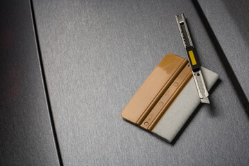 Brushed aluminium foil with wrapping tools close up