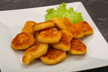 Fried chicken nuggets served salad leaves