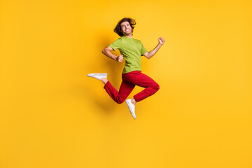 Fototapeta na wymiar Full length body size side profile photo of jumping high man hurrying on sale isolated on vibrant yellow color background