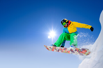 Snowboarder Jumping on Snowboard in the Mountains. Snowboarding and Winter Sports